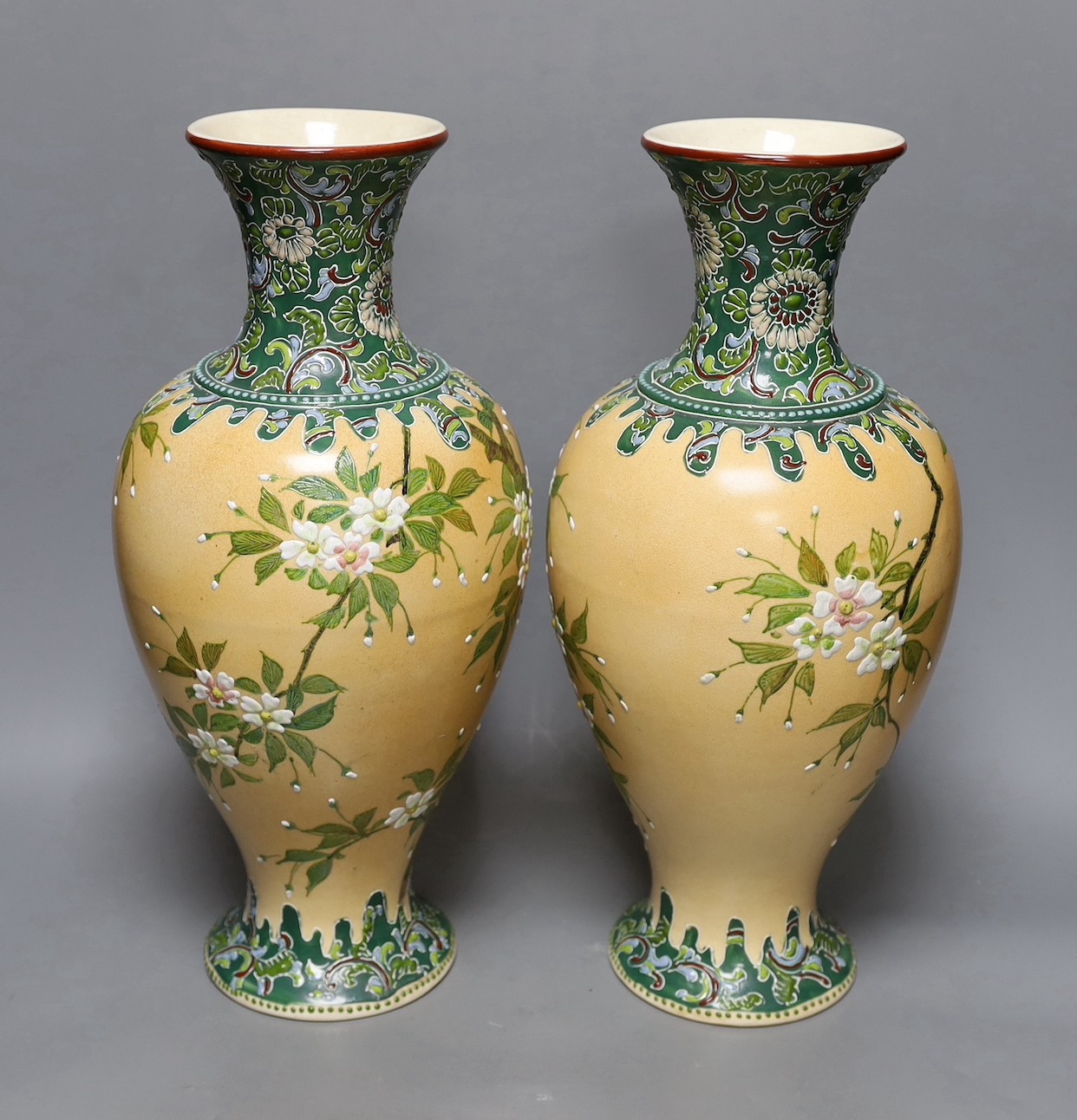 A pair of Japanese Satsuma style cream ground moriage vases, 40cm